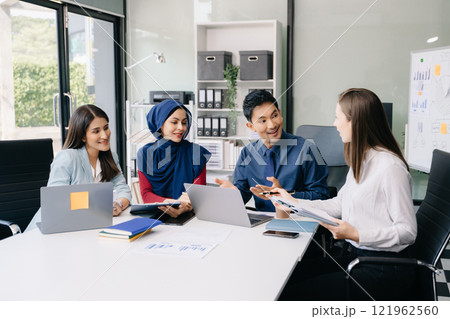 Multiracial group of young creative people in smart casual wear discussing business brainstorming meeting ideas design project. Multiracial group of young creative people in smart casual wear discussing business brainstorming meeting ideas design project. 121962560