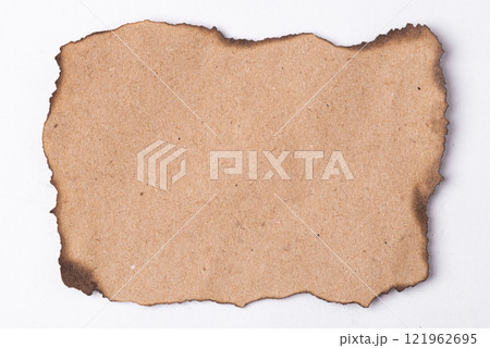 A piece of white paper with burnt edges on a white background A piece of white paper with burnt edges on a white background 121962695