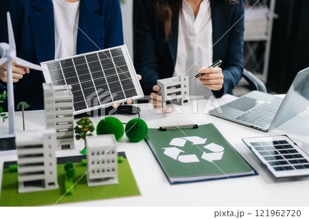 business team people planning and discussing on recycle reduce reuse policy symbol in office room. Green business company and Solar Energy Environment city Concept. 121962720