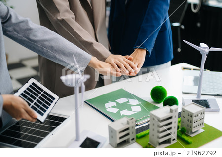 Business people having consultation about wind energy at company office. Business team discussing about windmill and alternative green enery. Executive meeting Business people having consultation about wind energy at company office. Business team discussing about windmill and alternative green enery. Executive meeting 121962792