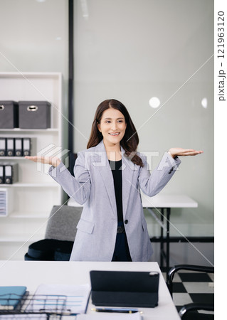 Young Asian male office worker business suits smiling at camera in office . teamwork startup concept Young Asian male office worker business suits smiling at camera in office . teamwork startup concept 121963120