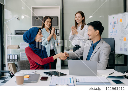Business partnership handshake concept.Photo Multiracial team coworkers handshaking process.Successful deal after great 121963412