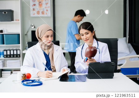 Doctors analyzing results or diagnosis of patient in clinic. Teamwork, medical and healthcare workers in discussion and research on desk in hospital Doctors analyzing results or diagnosis of patient in clinic. Teamwork, medical and healthcare workers in discussion and research on desk in hospital 121963511