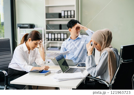 Furious two Asian businesspeople arguing strongly after making a mistake at work Furious two Asian businesspeople arguing strongly after making a mistake at work 121963723