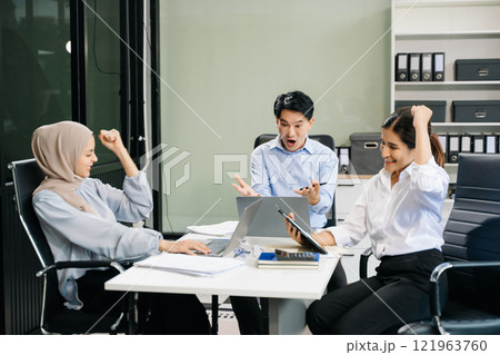 Happy businesspeople while collaborating on a new project in an office. 121963760