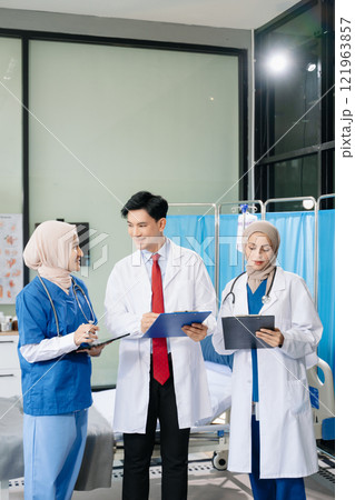 Doctors and nurses working together in a hospital ward, showcasing professionalism, teamwork Doctors and nurses working together in a hospital ward, showcasing professionalism, teamwork 121963857