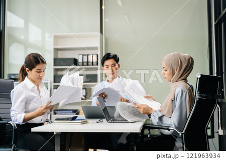 Asian businesspeople while collaborating on a new project. using a laptop and tablet Asian businesspeople while collaborating on a new project. using a laptop and tablet 121963934