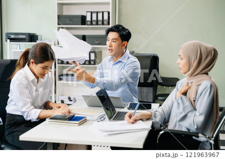Furious two Asian businesspeople arguing strongly after making a mistake at work Furious two Asian businesspeople arguing strongly after making a mistake at work 121963967