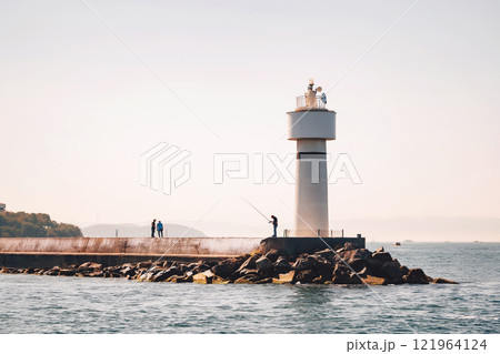 lighthouse on the shore of the bosphorus. embankment in istanbul with a fisherman 121964124