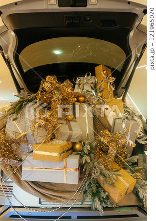 Christmas decorations on a car in the showroom. New Year's decoration by car 121965020
