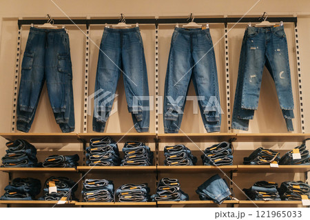 jeans on the store shelf. denim items on sale in the showroom 121965033