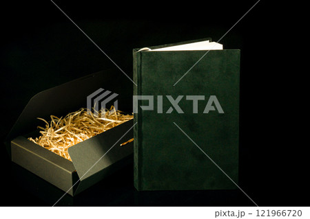 Best gift for men. Man gift concept. Black notebook with black gift box on black background. Copy space text. Valentine's day, wedding, birthday and special occasion gift concept. Copy space for text. 121966720