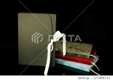 Best gift for men. Man gift concept. Various notebooks with craft gift box black background. Copy space text. Valentine's day, wedding, birthday and special occasion gift concept. Copy space for text. 121966725