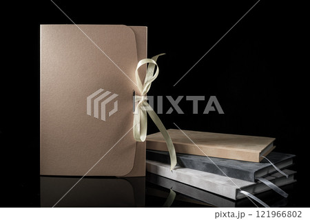 Best gift for men. Man gift concept. Various notebooks with craft gift box black background. Copy space text. Valentine's day, wedding, birthday and special occasion gift concept. Copy space for text. Best gift for men. Man gift concept. Various notebooks with craft gift box black background. Copy space text. Valentine's day, wedding, birthday and special occasion gift concept. Copy space for text. 121966802