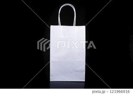 Recyclable craft paper bag for purchases, gifts and takeaway food mock up on black background. Environmentally friendly than single-use plastic bags Recyclable craft paper bag for purchases, gifts and takeaway food mock up on black background. Environmentally friendly than single-use plastic bags 121966816