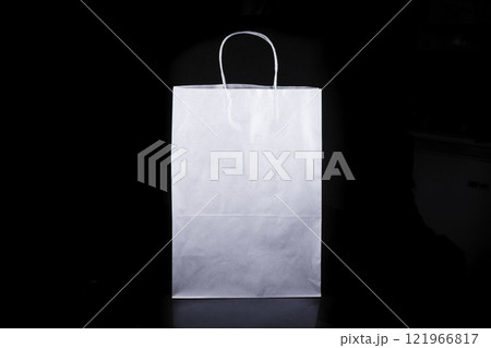 Recyclable craft paper bag for purchases, gifts and takeaway food mock up on black background. Environmentally friendly than single-use plastic bags Recyclable craft paper bag for purchases, gifts and takeaway food mock up on black background. Environmentally friendly than single-use plastic bags 121966817