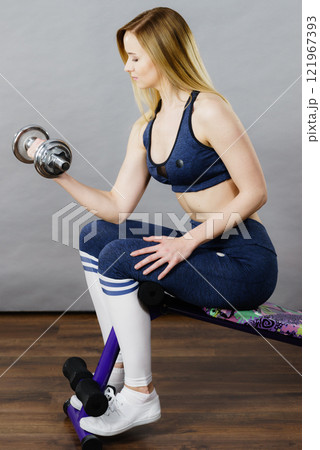 Woman training on bench for sit ups 121967393