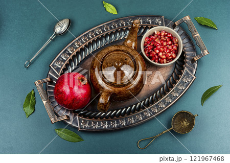 Hot fruit pomegranate tea in teapot. Hot fruit pomegranate tea in teapot. 121967468
