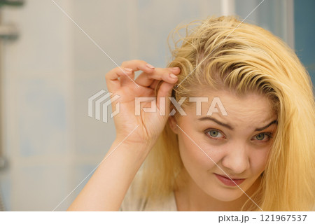 Female having problem with blonde hair 121967537