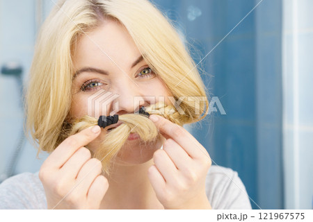 Woman making moustache braided hair Woman making moustache braided hair 121967575