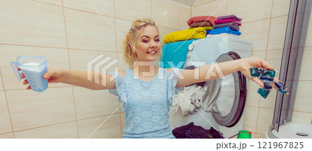 Girl wash laundry with different detergent. Girl wash laundry with different detergent. 121967825