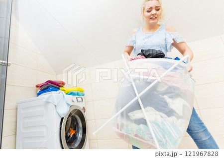 Woman carry big basket of dirty clothes laundry. Woman carry big basket of dirty clothes laundry. 121967828