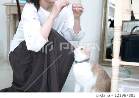 猫とじゃれ合うミドルの女性 121967883