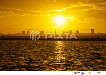 Sunset over sea and urban coastline 121967956