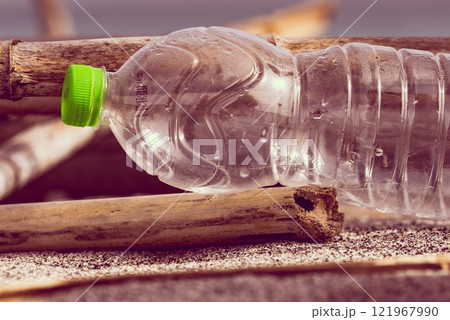 Plastic empty water bottle abandoned on nature 121967990