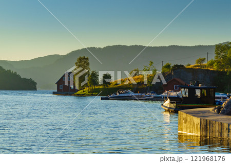Wooden cabin on fjord shore, Norway Wooden cabin on fjord shore, Norway 121968176