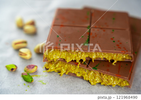 Trend Dubai chocolate with pistachio paste and kataifi dough. Confectionery handmade sweets at home in the kitchen.  121968490