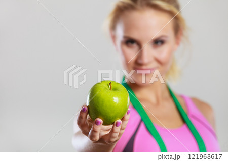 woman fit girl with measure tape and apple fruit 121968617