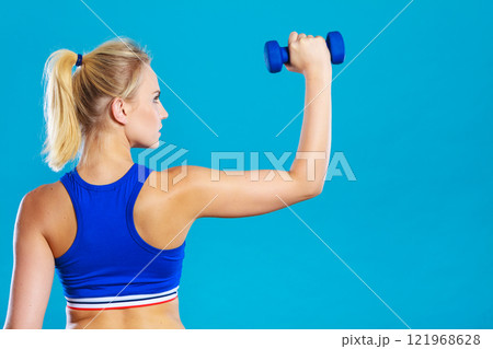 Fit woman lifting dumbbells weights Fit woman lifting dumbbells weights 121968628