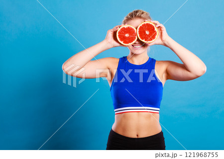 Woman holding grapefruit citrus fruit in hands Woman holding grapefruit citrus fruit in hands 121968755