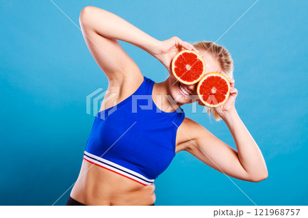 Woman holding grapefruit citrus fruit in hands Woman holding grapefruit citrus fruit in hands 121968757