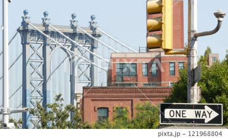 New York City Manhattan Bridge view from Brooklyn Bridge. Red brick residential building windows. 121968804