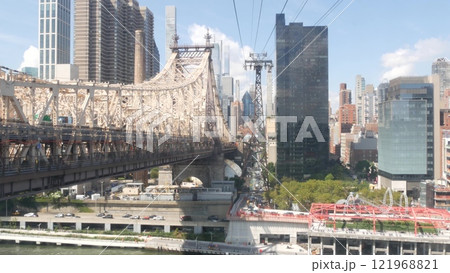 New York City Roosevelt Island tramway to Manhattan Midtown. Cable tram and Queensboro Bridge, USA. 121968821