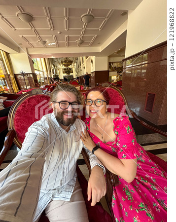 Smiling couple enjoying their time together in a luxurious and elegant hotel lounge. Relationship, love, Valentines day and ornate interior design concept 121968822