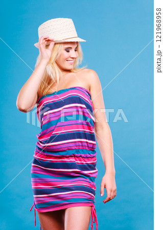 Blonde woman wearing short colorful striped dress Blonde woman wearing short colorful striped dress 121968958