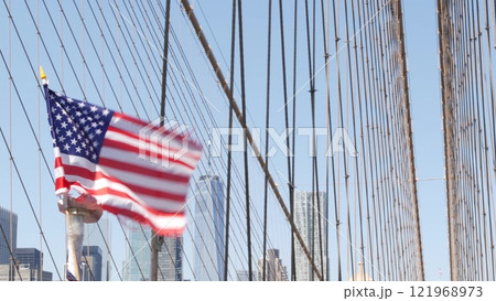 American flag on Brooklyn Bridge to Manhattan, New York City. Patriotic symbol. Travel USA. 121968973