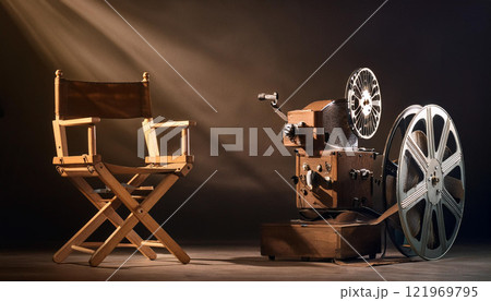 A wooden chair and a projector are on a dark background A wooden chair and a projector are on a dark background 121969795