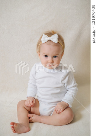 close up of laughing happy child in white clothes, little smiling girl 121970439