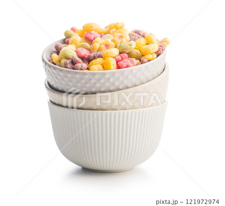 Colorful breakfast cereals in the shape of various fruit in bowl isolated on white background. 121972974