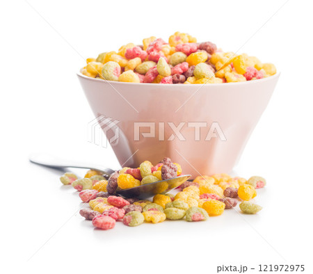 Colorful breakfast cereals in the shape of various fruit in bowl isolated on white background. Colorful breakfast cereals in the shape of various fruit in bowl isolated on white background. 121972975