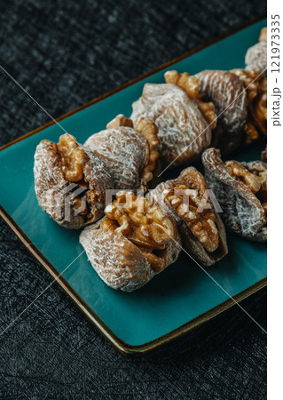 dried figs filled with walnuts on a plate dried figs filled with walnuts on a plate 121973335