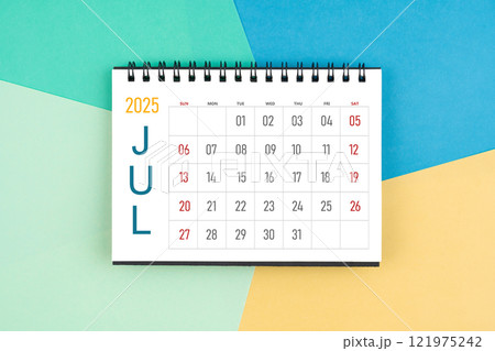 July 2025 month blank desk calendar on colorful background. 121975242
