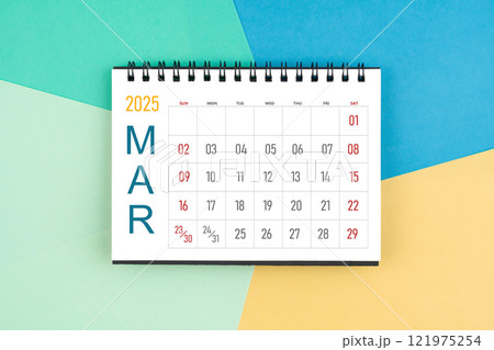 March 2025 month blank desk calendar on colorful background. 121975254