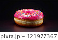 Delicious pink frosted donut with colorful sprinkles on a dark background 121977367