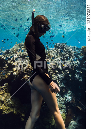 Beauty freediver underwater near coral reef rocks in tropical sea. 121978222