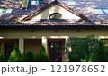 Beige house with a tiled roof and skylights nearby. The architecture of the building. Geometric correct photo 121978652